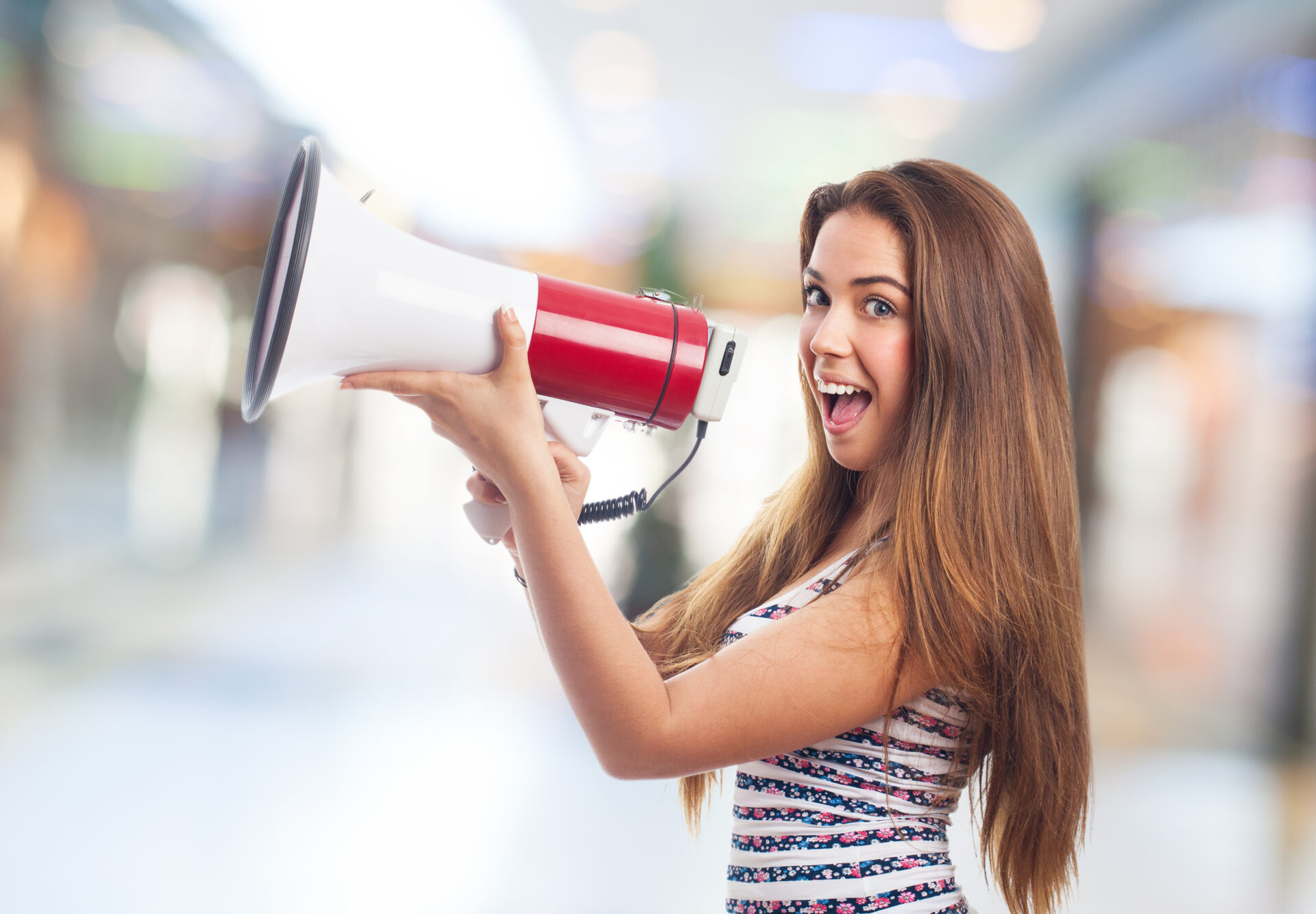portrait of a girl shouting with a megaphone
